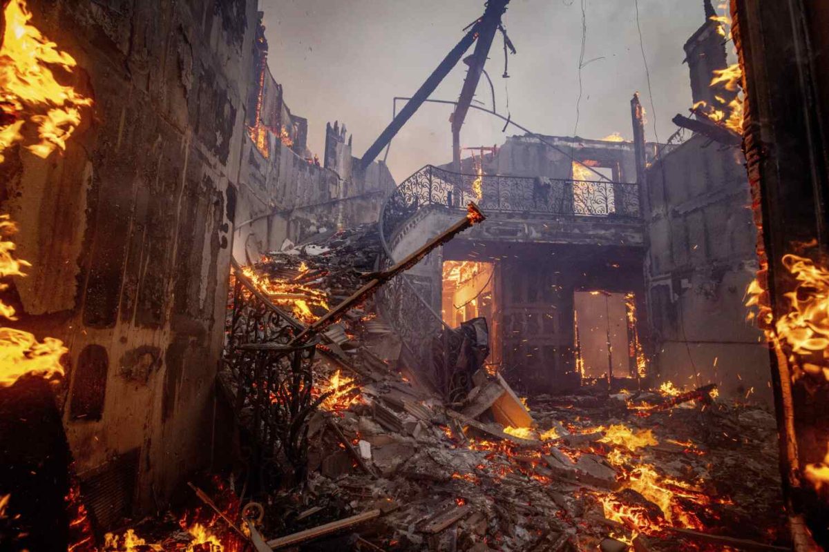 The Palisades Fire burns a residence in the Pacific Palisades neighborhood of Los Angeles, Tuesday, Jan. 7, 2025. (AP Photo/Etienne Laurent)