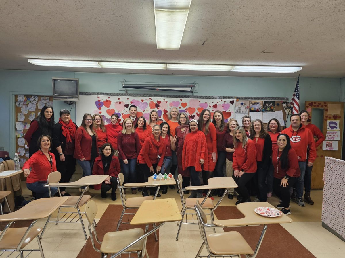 A faculty photo taken on a previous National Wear Red Day.